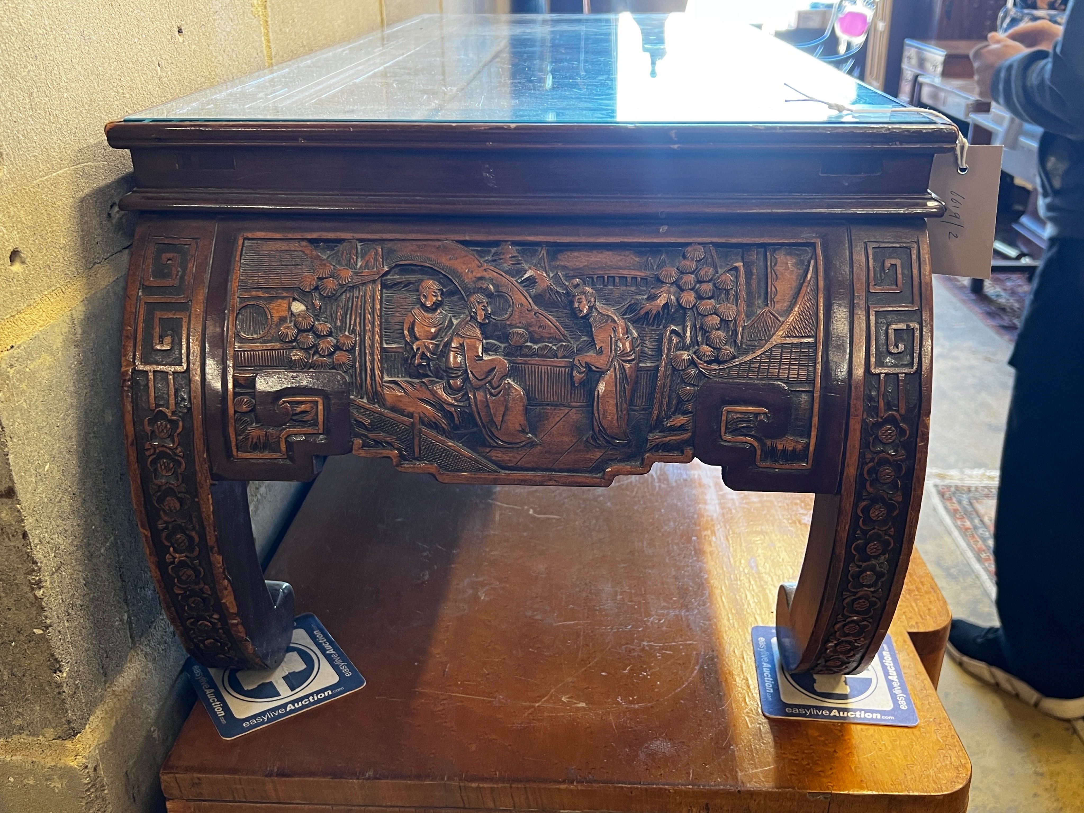 A Chinese carved hardwood low table, length 110cm, depth 43cm, height 36cm